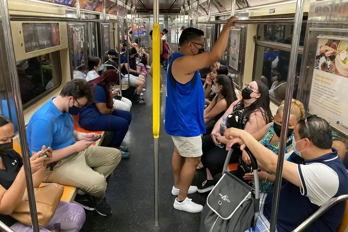 Commuters wear face masks while riding the subway in the Manhattan, June 6th, 2021